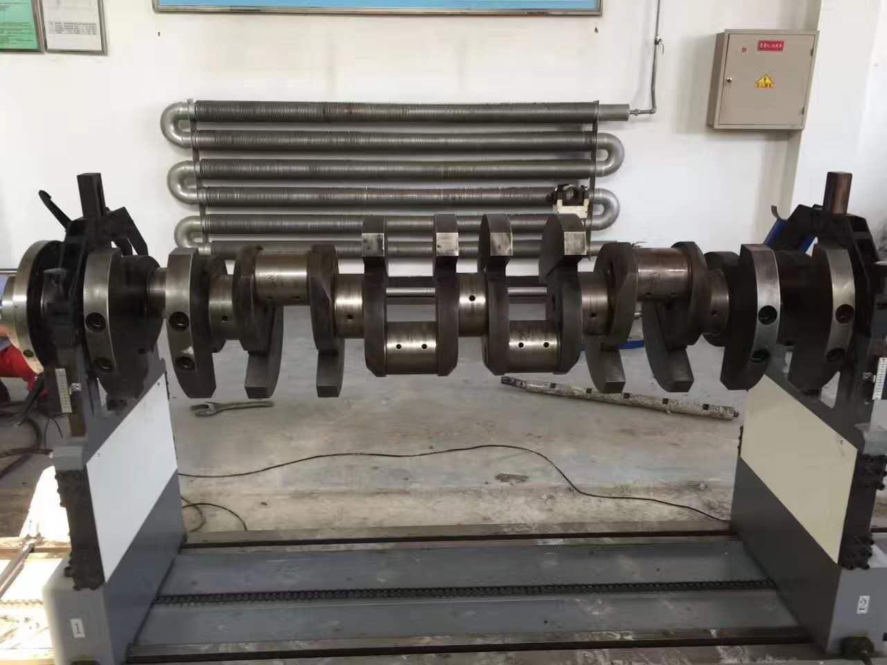 Design and Debugging of Mechanical System for Crankshaft Dynamic Balancing Machine